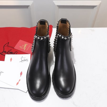 Christian Louboutine Black platform rivet boots.