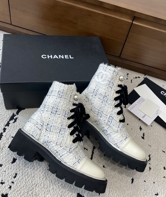 Chanel Elevated Leather Ankle Boots with Classic Fabric and Pearl Buttons