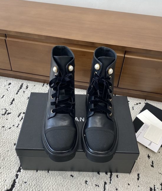 Chanel Elevated Leather Ankle Boots with Classic Fabric and Pearl Buttons
