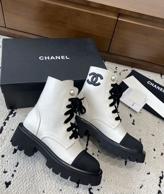 Chanel Elevated Leather Ankle Boots with Classic Fabric and Pearl Buttons
