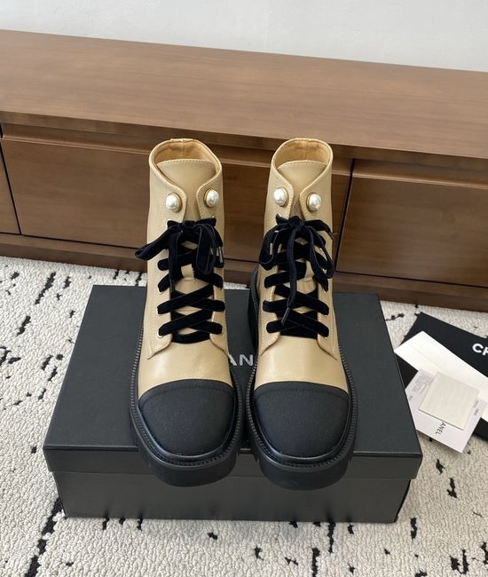 Chanel Elevated Leather Ankle Boots with Classic Fabric and Pearl Buttons