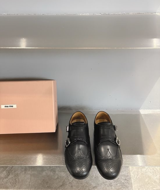 Miu Miu Engraved Brogue Loafers with Tassel Details