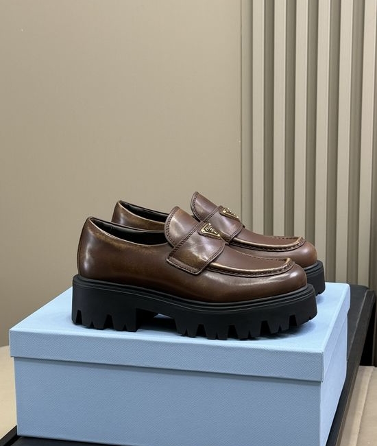 Prada Premium Leather Loafers With Gold Emblem And Chunky Heel